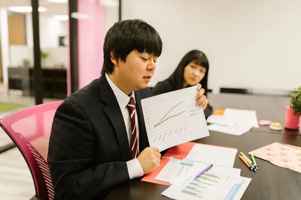 Colleagues discussing a business plan and reviewing charts